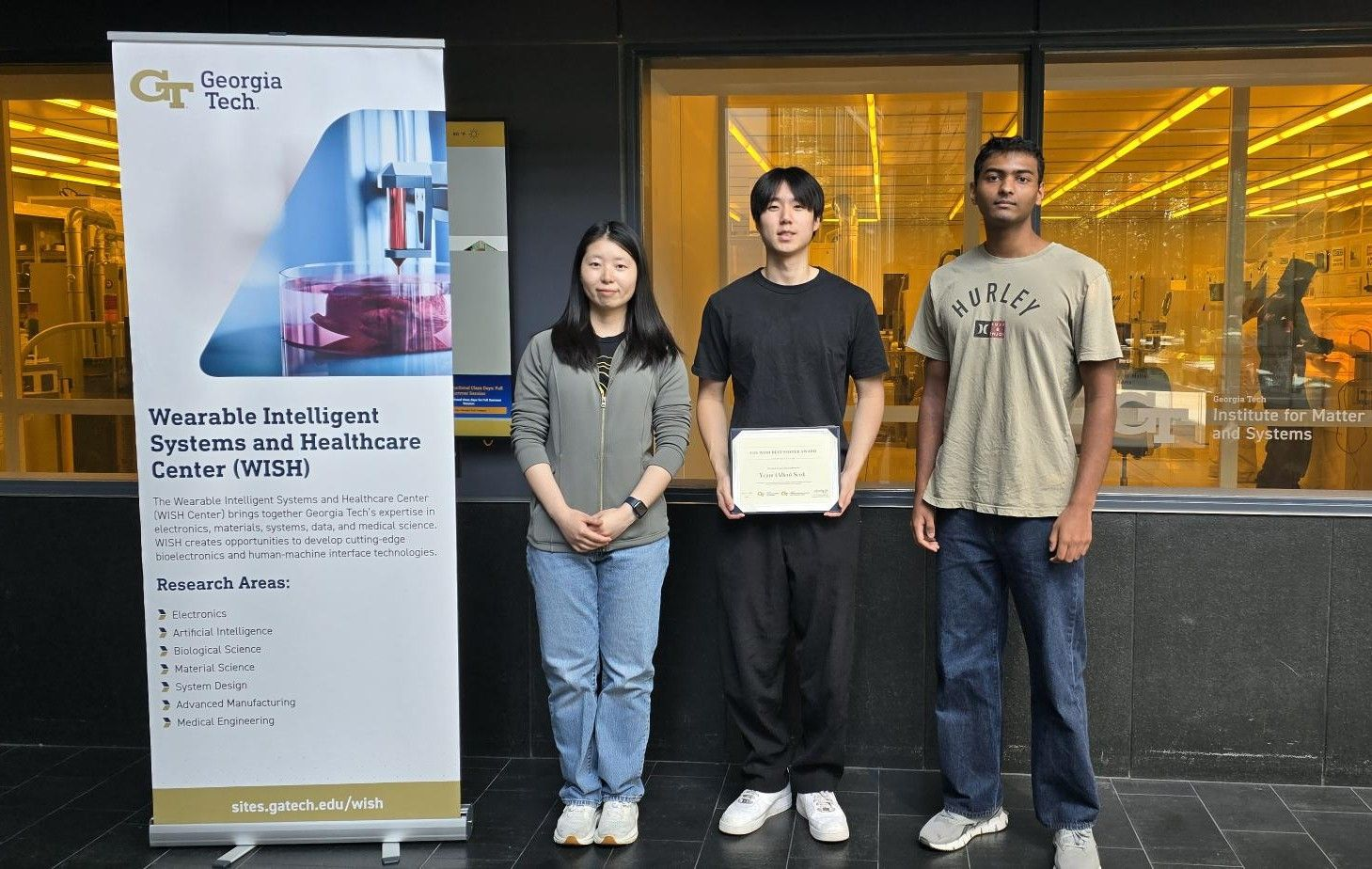 Shiqi Wei, Allen Seok holding his poster award, and a fellow student at the Georgia Tech WISH Center